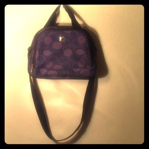 Women’s purse that is black with purple circles